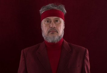 Studio shot closeup portrait of a bearded man in red