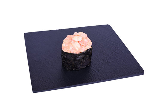 Traditional fresh japanese sushi on black stone Gunkan spicy abi on a white background. Gunkan ingredients: tiger shrimp, spicy sauce, nori, rice.