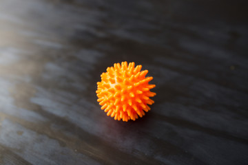 Novel coronavirus 2019-nCoV with copy space for text on dark background. Abstract virus strain orange model of Coronavirus disease COVID-19. Virus Pandemic Protection Concept