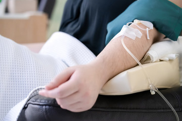 close up to Asian arm that receive vitamin from woman care clinic.