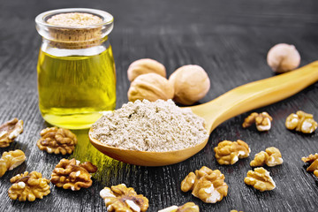 Flour walnut in spoon with oil on board