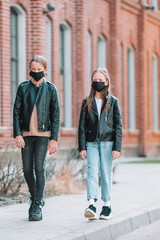 Girls wearing a mask on a background of a modern building,