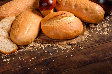 Fresh baked white bread on a brown concrete background