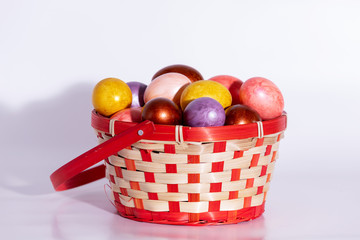 Fototapeta na wymiar Easter eggs in basket isolated on white