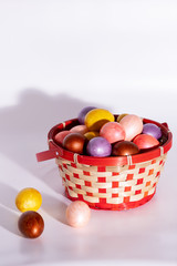 Easter eggs in basket isolated on white
