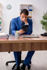 Young male businessman employee working in the office