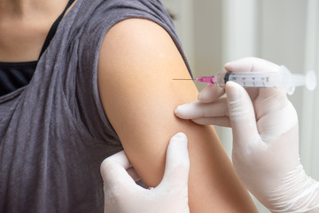 Asian women come to receive vaccinations to prevent disease.
