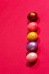 Easter painted eggs isolated on red background