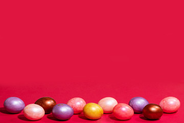 Easter painted eggs isolated on red background