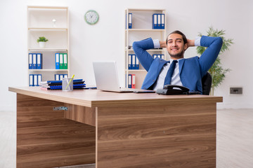 Young male businessman employee working in the office