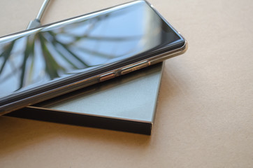 Smartphone is charged on a rectangular induction charger.