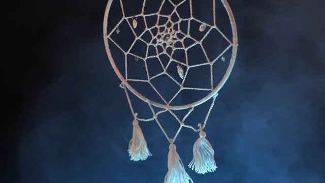 Mystical attribute dreamcatcher on a black background with smoke