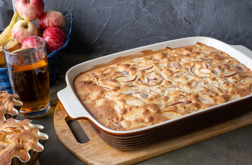 Cooking apple pie. Fruits -rustic apples on a platter on a dark background