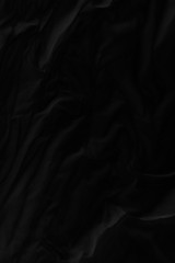 Black fabric texture for background; Abstract black fabric cloth wave or wavy folds texture material for background