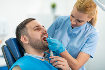 Portrait of male patient having treatment at dentist