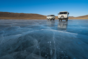 Deep ice surface of Bailkal lake in winter season with van, Siberia, Russia