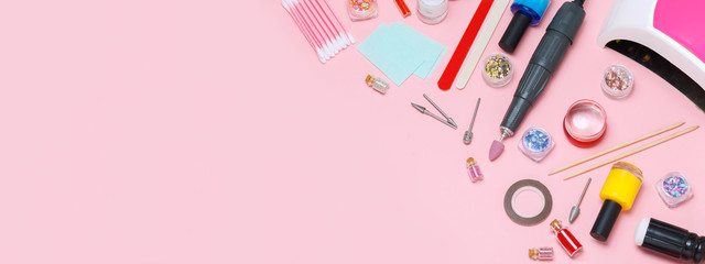 A set of cosmetic tools for manicure and pedicure on a white background. Gel polishes, nail files, manicure scissors, pusher and clippers top view. Composition for card with a place for text