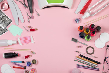 A set of cosmetic tools for manicure and pedicure on a white background. Gel polishes, nail files, manicure scissors, pusher and clippers top view. Composition for card with a place for text - obrazy, fototapety, plakaty