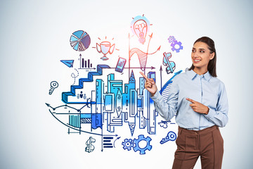 Smiling girl showing colorful business plan sketch