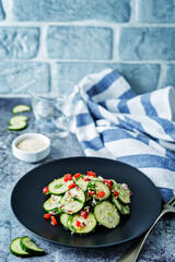 Cucumber spice salad with red onion, red pepper and sesame seeds