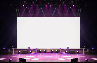 An empty stage of the theater, lit by spotlights and smoke before the performance