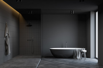 Fototapeta na wymiar Dark grey bathroom with tub and shower