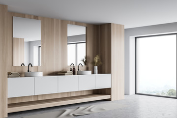 Double sink in white and wooden bathroom corner