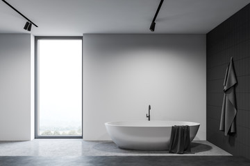 White and black bathroom interior with tub