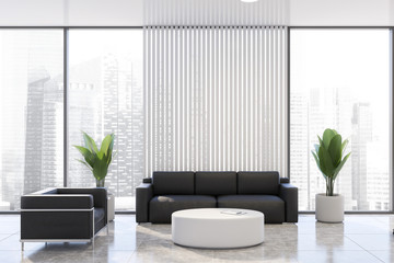 White office waiting room with black sofa