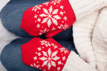 Red mittens on hands