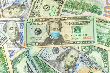 Face mask on Andrew Jackson American 20 dollars banknote. Business concept of Covid 19-NCP virus pandemic in the United States. Covid-19 Coronavirus outbreak and the American money market.