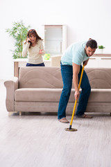 Young couple and snake in the flat