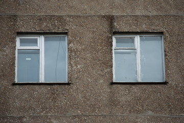 Fototapeta na wymiar windows prefabricated house ussr Khrushchev glass straight concrete gray russia balcony