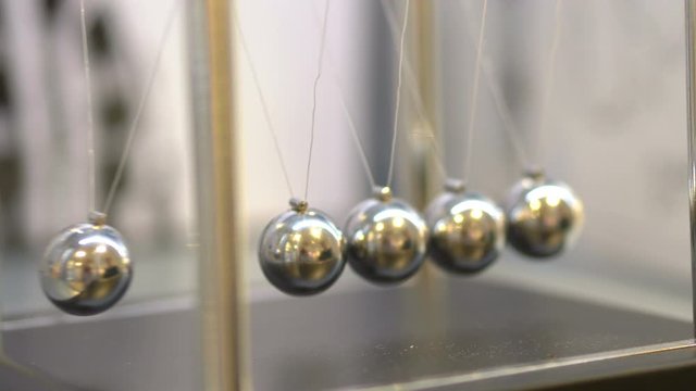 Pendulum With Swinging Metal Spheres in 4K slow motion 60fps