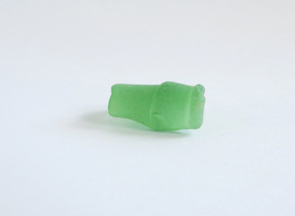 bottleneck, piece of a green bottle grinded by the tide of the sea