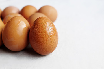 Fresh chicken eggs on white concrete floor background. The benefits of eating eggs are high protein. Copy Space