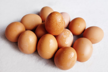 Fresh chicken eggs on white concrete floor background. The benefits of eating eggs are high protein.