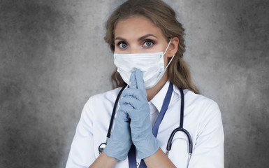 Medical staff preventive gear against coronavirus. Portrait of female doctor with stethoscope in mask.