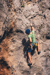 Man climbs a rock. 