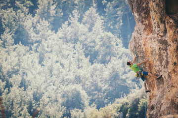 Man climbs a rock. 