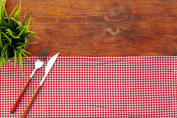 Red checkered napkin or tablecloth  on wooden table, copy space