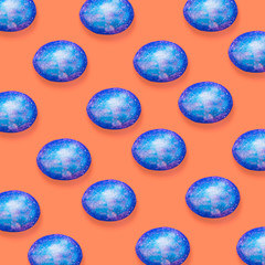 Creative art collage. Pattern of Easter colored eggs on an orange background.