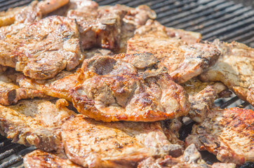 sausages and pork steaks on the large barbeque
