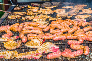 sausages and pork steaks on the large barbeque