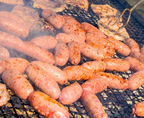 sausages and pork steaks on the large barbeque