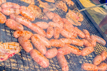 sausages and pork steaks on the large barbeque