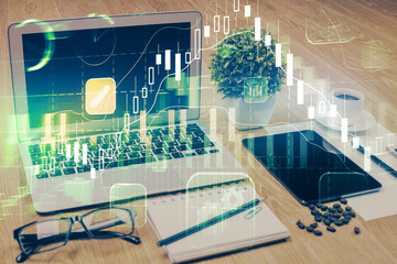 Double exposure of forex chart and work space with computer. Concept of international online trading.