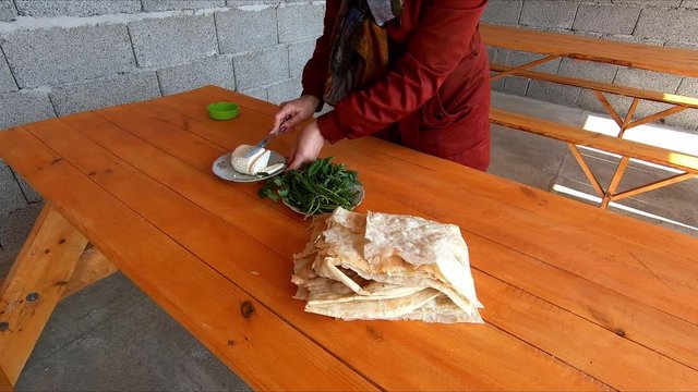 Traditional Armenian cuisine: pita bread, cheese, greens.