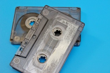 Old audio cassettes are located on a blue background
