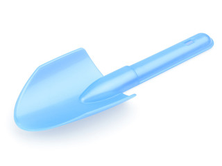 Children's blue shoulder blade. A shovel for playing with sand. Shoulder blade on a white background. The concept of the construction